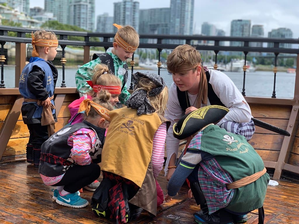 Pirate Adventures crew with young pirates aboard the Black Spirit